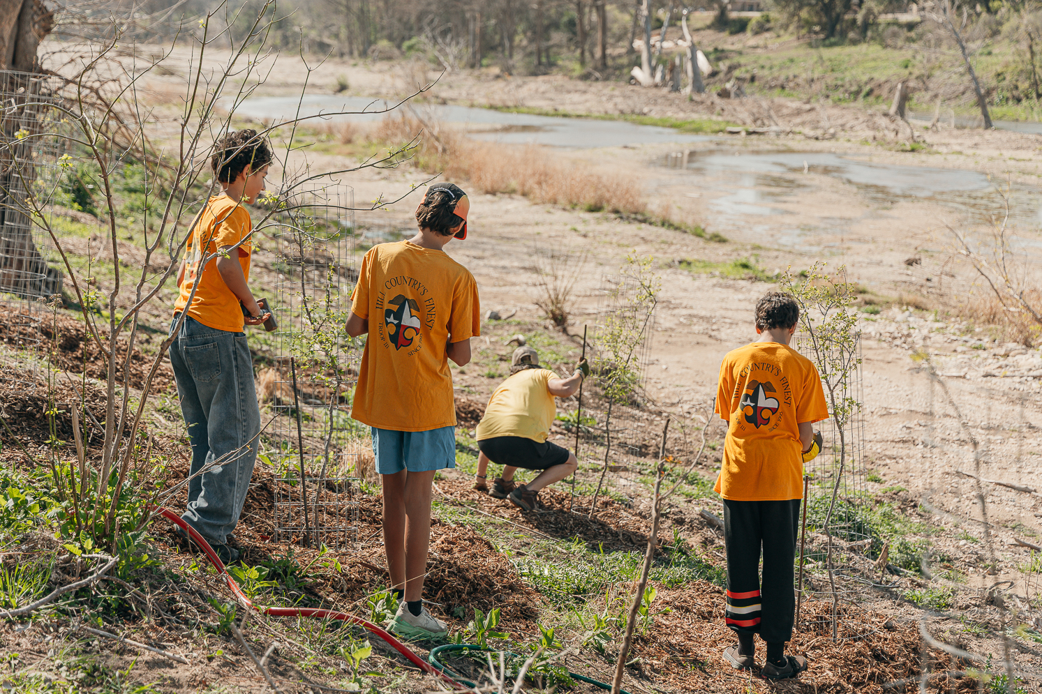 Volunteers planting native trees along the Guadalupe River trail